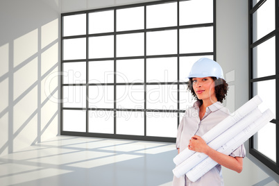 Composite image of confident woman holding construction plans