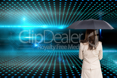 Composite image of rear view of classy businesswoman holding umb