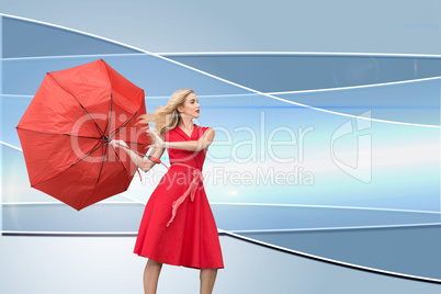 Composite image of elegant blonde holding umbrella