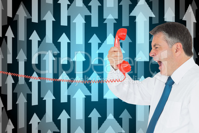 Composite image of businessman screaming directly into the hands