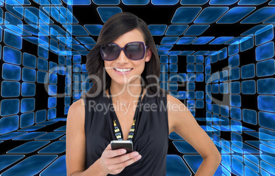 Composite image of happy brunette holding smartphone