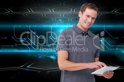 Composite image of smiling young man with tablet computer