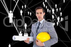 Composite image of serious architect holding plans and hard hat