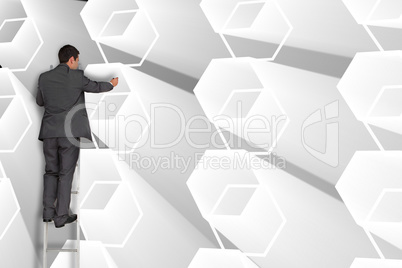 Composite image of businessman standing on ladder