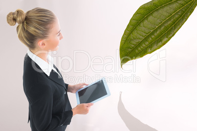 Composite image of businesswoman holding new tablet