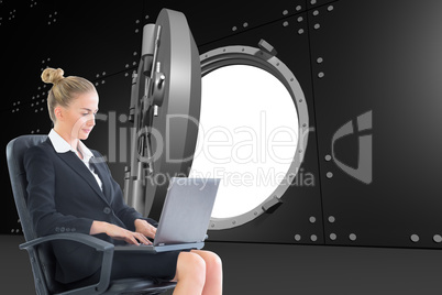 Composite image of businesswoman sitting on swivel chair with la