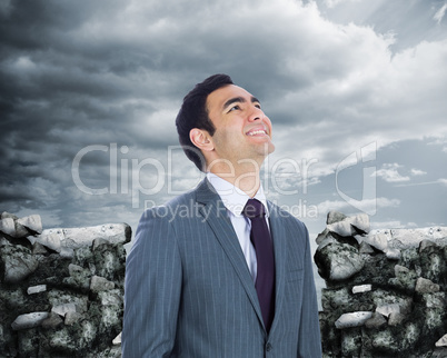 Composite image of smiling businessman standing