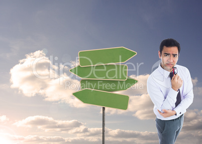 Composite image of thinking businessman holding glasses