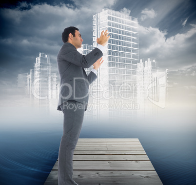 Composite image of unsmiling businessman with arms raised