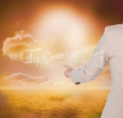 Composite image of businesswoman pointing