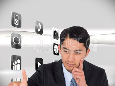 Composite image of thoughtful asian businessman pointing