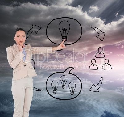 Composite image of thoughtful asian businesswoman pointing