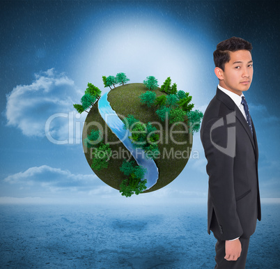 Composite image of serious businessman looking at camera