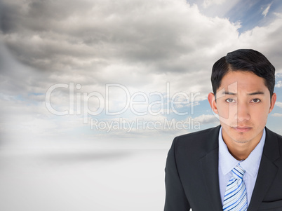 Composite image of serious asian businessman