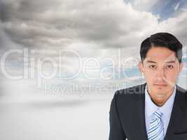 Composite image of serious asian businessman