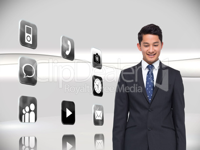Composite image of smiling businessman looking down