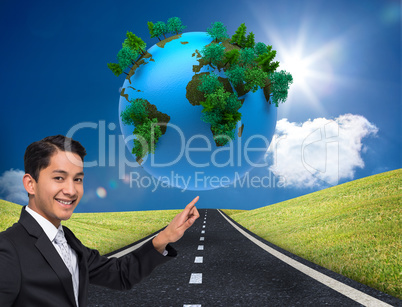 Composite image of smiling asian businessman pointing