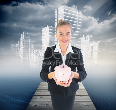 Composite image of businesswoman holding pink piggy bank