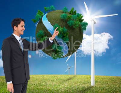 Composite image of smiling asian businessman pointing