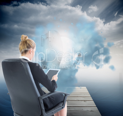 Composite image of businesswoman sitting on swivel chair with ta