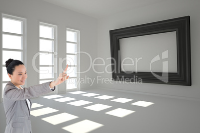 Composite image of smiling asian businesswoman pointing Composite image of smiling asian businesswoman pointing