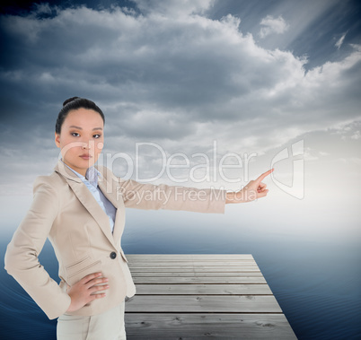 Composite image of unsmiling asian businesswoman pointing