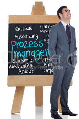 Composite image of smiling businessman standing