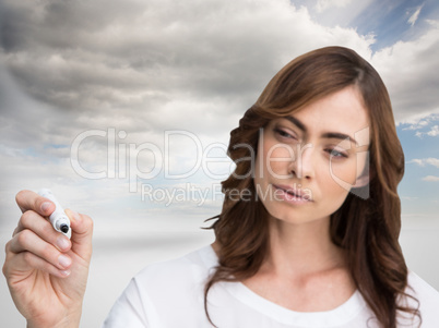 Composite image of concentrated businesswoman holding whiteboard