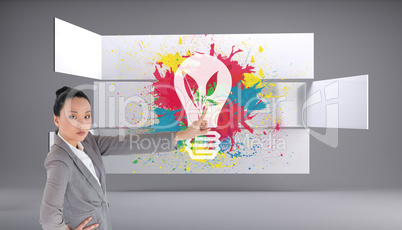 Composite image of unsmiling asian businesswoman pointing