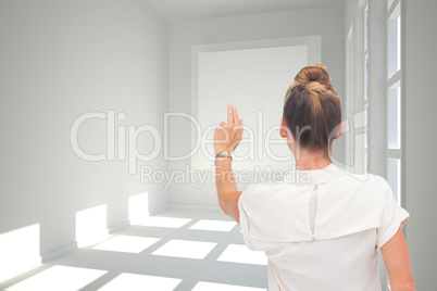 Composite image of businesswoman touching something