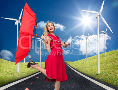 Composite image of elegant blonde holding umbrella