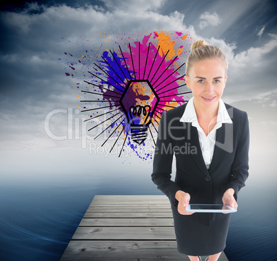 Composite image of businesswoman holding new tablet