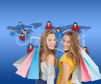 Composite image of two young women with shopping bags