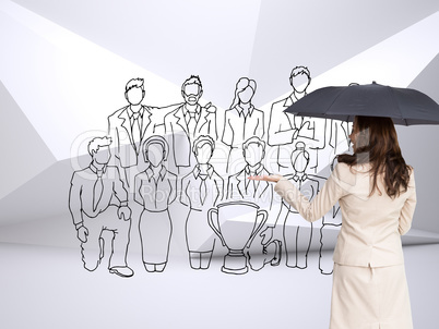 Composite image of elegant businesswoman holding black umbrella