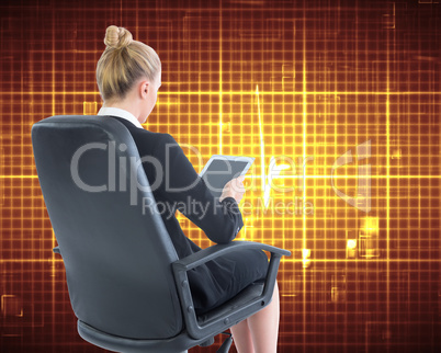 Composite image of businesswoman sitting on swivel chair with ta