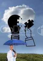 Composite image of businessman holding umbrella smiling at camer