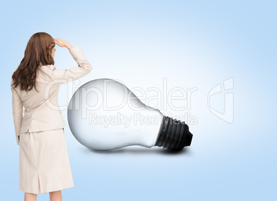 Composite image of rear view of young businesswoman looking away