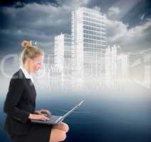Composite image of businesswoman using laptop