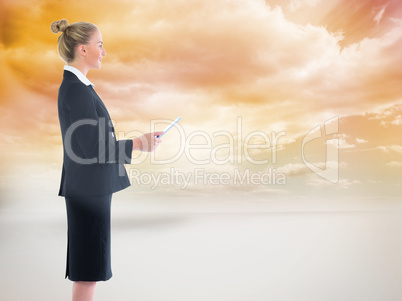 Composite image of businesswoman holding new tablet