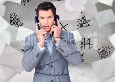 Composite image of angry businessman tangle up in phone wires