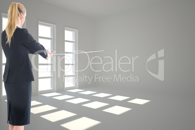 Composite image of businesswoman pulling a rope