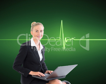 Composite image of businesswoman using laptop