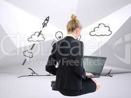 Composite image of businesswoman using laptop