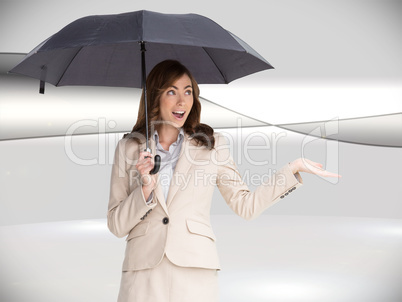 Composite image of elegant businesswoman holding black umbrella