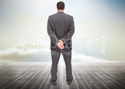 Composite image of rear view of classy businessman posing