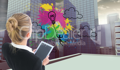 Composite image of businesswoman holding new tablet