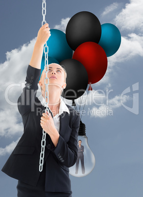 Composite image of businesswoman pulling a chain