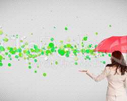 Composite image of businesswoman holding umbrella