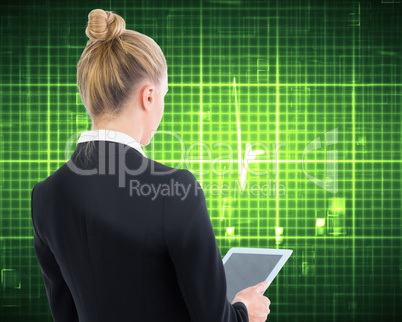 Composite image of businesswoman holding tablet