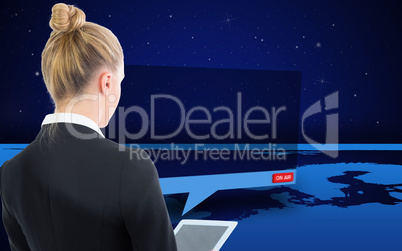 Composite image of businesswoman holding tablet